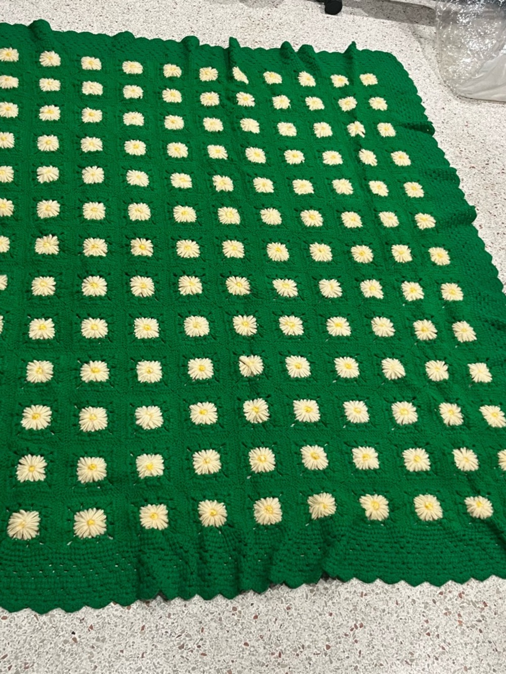 Crochet grass green daisy blanket.